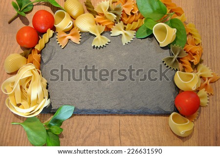 Three different types of colored pasta on wood