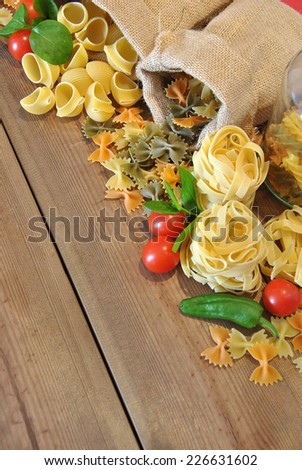 Three different types of colored pasta on wood