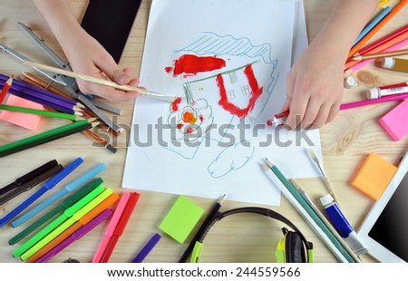 hands of girl painting a picture on your desktop