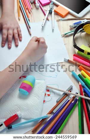 hands of girl painting a picture on your desktop