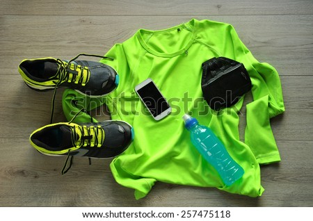 Clothes make running with isotonic drink, phone and T-shirt