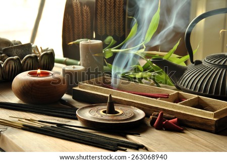 VARIOUS TYPES OF INCENSE WITH TEAPOT AND BUDDHA STATUE