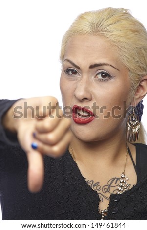 A woman with very fair hair and a dark blouse holding a single thumb down to show that sheÃ?Â?Ã?Â´s disgusted. The person is exempted on a white background.