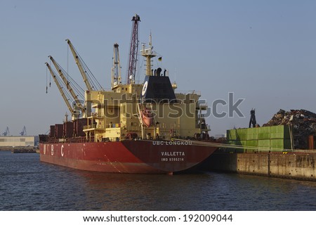 HAMBURG; GERMANY - APRIL, 19. Scap metal (iron) is loaded on the vessel UBC Longkou on April 2014, 19.