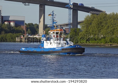 HAMBURG, GERMANY - MAY, 16. The tugboat Fair Play X under the Koehlbrand Bridge in Hamburg taken on May 16, 2014.