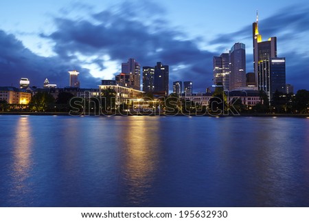 FRANKFURT, GERMANY - MAY 9. The skyline of Frankfurt with big skyscrapers of banking companies and dark grey rain clouds taken in the evening (blue hour) of May 9, 2014.