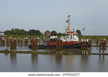 BRUNSBUETTEL, GERMANY - JUNE, 7. The tug boat Arion at the lockage Brunsbuettel (Schleswig-Holstein, Germmany) to the Kiel Canal in front of the newly repaired lock chamber on June 7, 2014.