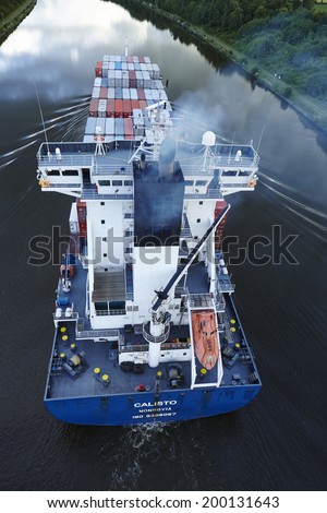 BELDORF, GERMANY - JUNE, 14. The exhaust fumes of the container vessel Calisto on the Kiel Canal near Beldorf (Schleswig-Holstein, Germany) taken in the early evening on June 14, 2014.