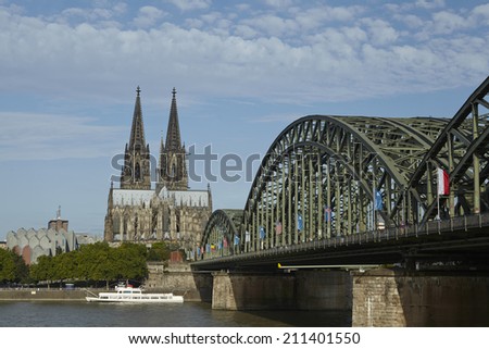 COLOGNE, GERMANY - AUGUST 17. The Cologne Cathedral (Northrhine-Westphalia, Germany) and the Hohenzollern Bridge at the river Rhine taken on August 17, 2014.