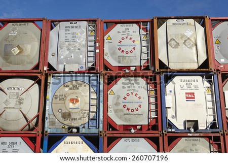 HAMBURG, GERMANY - MARCH, 8. A pile of tank container (tanktainer) of different haulage firms taken at the port of Hamburg against a bright blue sky on March 8, 2015.