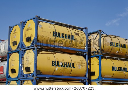HAMBURG, GERMANY - MARCH, 8. A pile of tank container (tanktainer) of different haulage firms taken at the port of Hamburg against a bright blue sky on March 8, 2015.