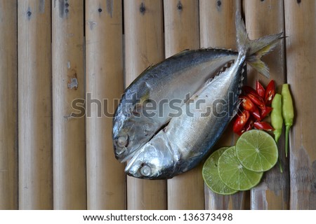 Boiled fish with chili on bamboo