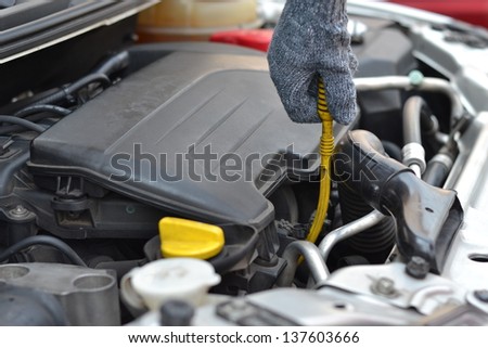 checking the oil level in the engine bay of vehicle