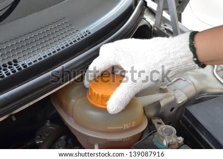Check coolant level in white gloves for the hands
