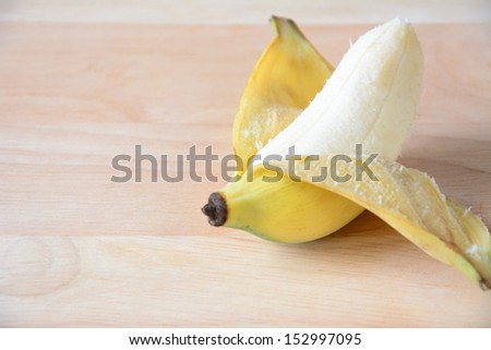 Open banana isolated on wood.