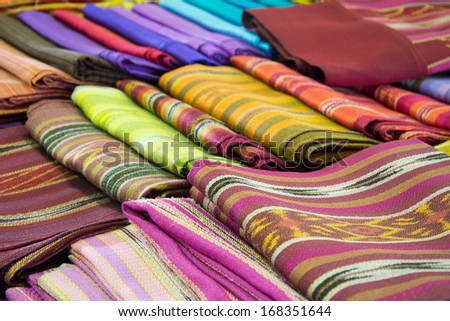 A collection of Thai silk cloths and Multicolored striped