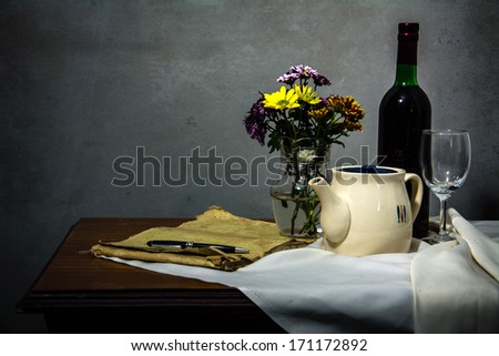 Still life with fish, fruit, vegetables and wine in a silver plate.