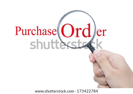 Hand Showing Purchase Order Word Through Magnifying Glass