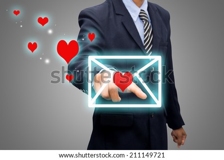 Business man pointing envelope heart.
