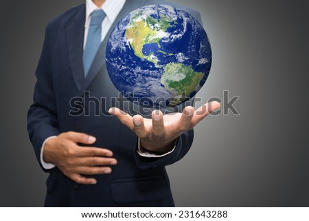 Businessman hand holding globe with Earth in the background 