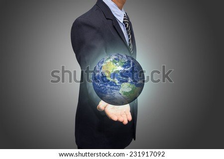 Businessman hand holding globe with Earth in the background \