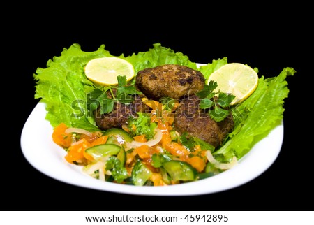 chops and lettuce on a black background