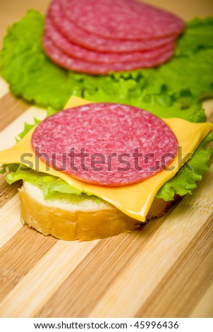 sandwich with sausage on a wooden board