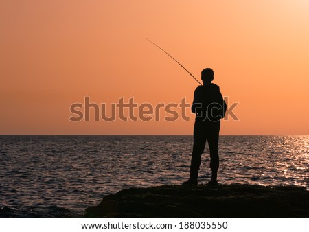 Fishing silhouette at sunset sunrise