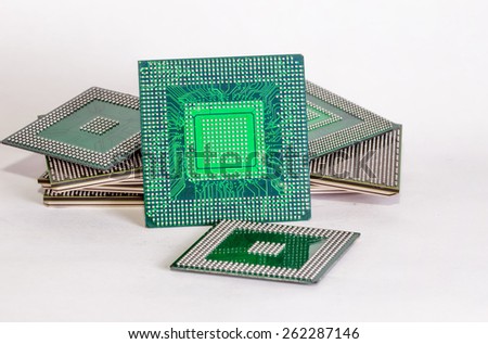 Stack of computer electronic chips isolated on white. The chips are placed upside down or facing the viewer. there are different chips in the stack