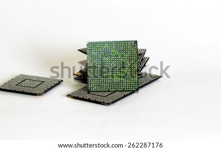 Stack of computer electronic chips isolated on white. The chips are placed upside down or facing the viewer. there are different chips in the stack
