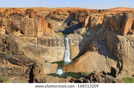 Oranje river landscape - waterfall and stone desert. Republic of South Africa