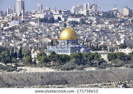 Magnificent panorama of Jerusalem. Dome of the Rock and Dome of the Holy Sepulcher. On a background - modern skyscrapers and elevating cranes of new buildings