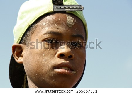 Hard working poor malagasy boy with dirty face - poverty in Madagascar