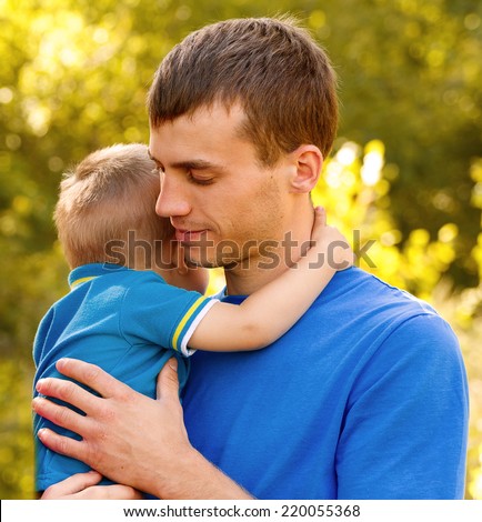 father holding his son and hugs him