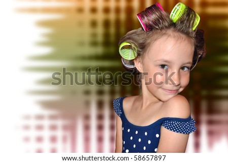Portrait small girl with twist on curlers hair.