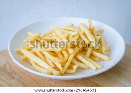 French fries or French-fried potatoes on a white dish.