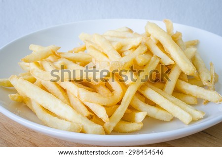 French fries or French-fried potatoes on a white dish.