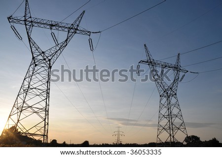 Electric power utility poles  on the sunset sky