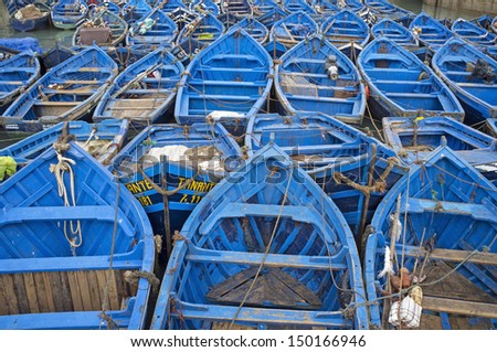 ESSAOUIRA, MOROCCO - OCTOBER 26: Small wooden fishing boats on October 26, 2012  inside the historic harbor of Essaouira in Morocco.