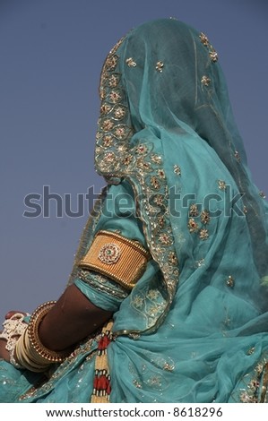 Lady dressed in ornate blue sari with gold and silver trim. Desert Festival Jaisalmer Rajasthan India