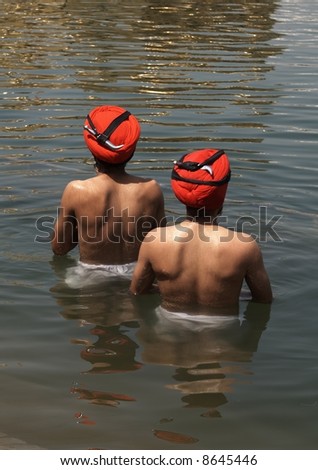 Sikh men bathing in the holy pool at the Golden Temple, Amritsar