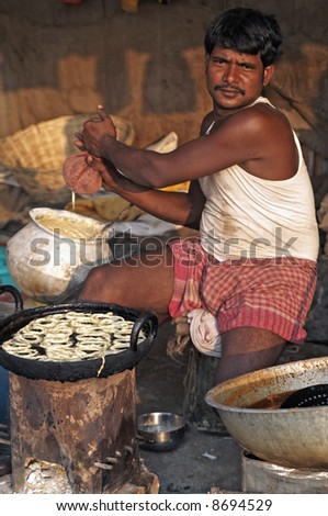 Indian street vendor preparing sweets for sale at the Sonepur livestock fair, India