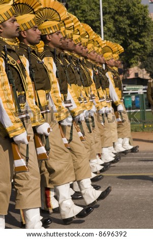 Soldiers in bright yellow trim parading down the Raj Path in preparation for the Republic Day Parade, New Delhi, India