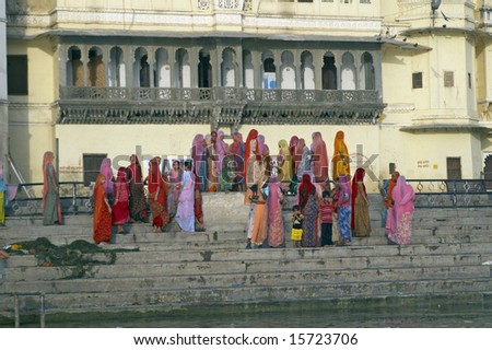 UDAIPUR, INDIA - JUNE 13: Group of unidentified Indian women in brightly colored sari\'s on the edge of Lake Pichola. June 14, 2007 in Udaipur, Rajasthan, India