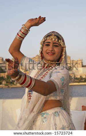 UDAIPUR, INDIA - JUNE 14: Unidentified female Indian dancer wearing ornate white outfit embellished with gold and silver jewelery. June 14, 2007 in Udaipur, Rajasthan, India