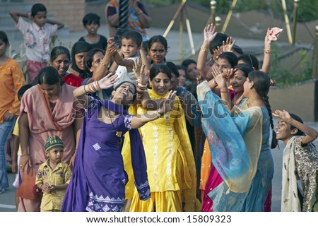 WAGAH BORDER POST, INDIA - JULY 24: Unidentified Indian women dancing in the street as part of the ceremony closing the border between India and Pakistan. July 24, 2008 in Wagah, Punjab, India