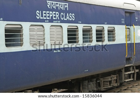 Sleeper carriage (3rd class) of Indian Railways. Bars across open windows. Delhi, India.