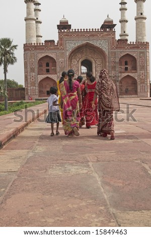 AGRA, INDIA - JULY 25: Unidentified Indian family in brightly colored clothing at the tomb of the Mughal Emperor, Akbar. July 25, 2008 in Agra, Uttar Pradesh, India.