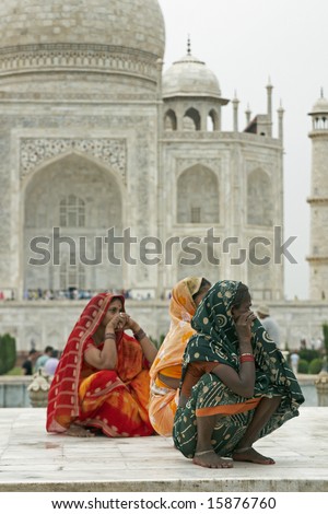 AGRA, INDIA - JULY 26: Unidentified Indian ladies in colorful sari\'s squatting on a white marble plinth at the Taj Mahal July 26, 2008 in Agra, Uttar Pradesh, India