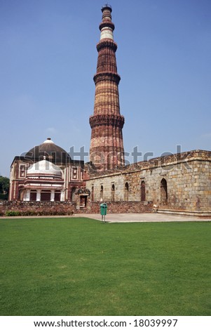 Qutb Minar. Ancient islamic victory tower in landscaped gardens. Delhi, India